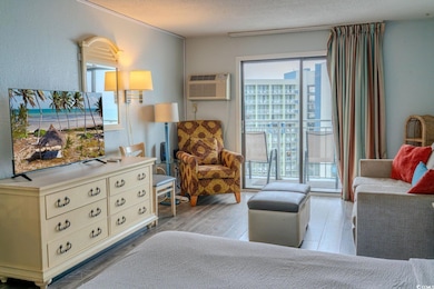 Bedroom with a wall mounted air conditioner, a tex