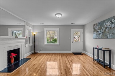 Entrance foyer with baseboards, wood finished floo