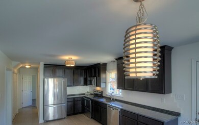 Fully updated kitchen with new lighting, tile floo