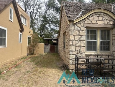 View of side of property featuring stone siding and stucco siding