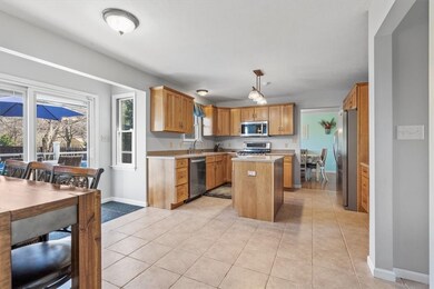 Open and bright, the rear of the home has plenty of space for entertainment. Eat-in kitchen features a bump-out design with sliding door for easy access to the deck/backyard.