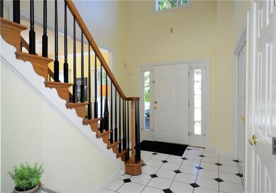 The inviting two story foyer is light and bright a