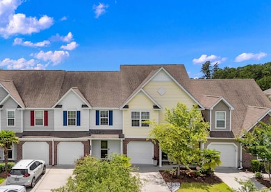 View of front of home with a garage, driveway, brick siding, and a shingled roof