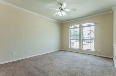 Carpeted spare room with ornamental molding, baseb