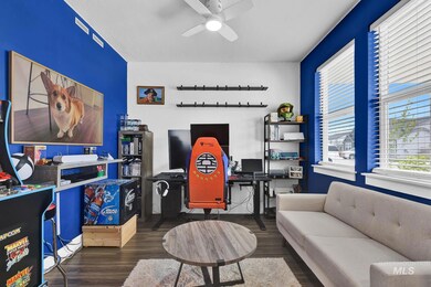 Office with wood finished floors and a ceiling fan