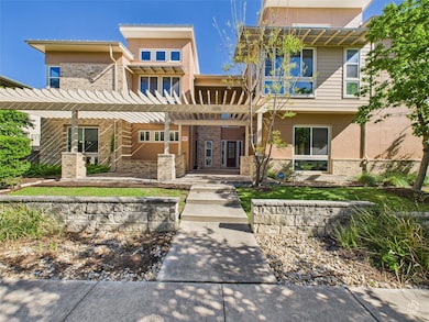 View of front of home with a pergola, brick sidin