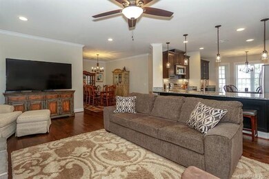 Open floorplan rooms connected by beautiful wood flooring