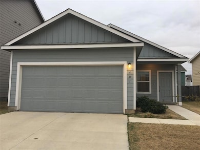 View of front of house with board and batten siding, concrete driveway, a garage, and covered porch