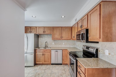Kitchen featuring sink, stainless steel appliances