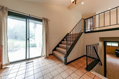 Welcoming foyer with sliding glass door to rear pa
