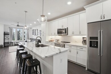 Kitchen with appliances with stainless steel finishes, a sink, recessed lighting, white cabinets, and backsplash