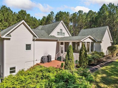 Back of property with a patio area, a sunroom, and