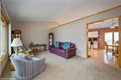 Front living room with large windows and open to k