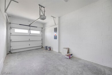 Garage with concrete block wall, electric panel, a