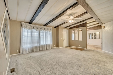 Empty room featuring carpet flooring and ceiling fan
