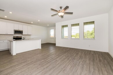 Kitchen with stainless steel appliances, white cabinets, a wealth of natural light, and hardwood / wood-style flooring
