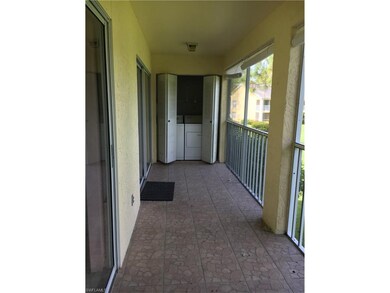 Long tiled screened lanai with washer and dryer