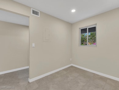 Spare room with baseboards, visible vents, and rec