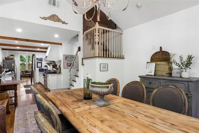 Dining room with cute staircase up to bonus room