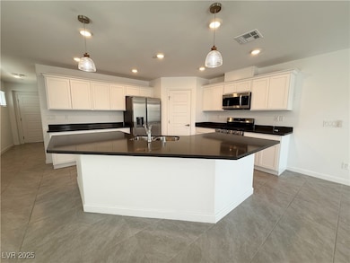 Kitchen with stainless steel appliances, a sink, d