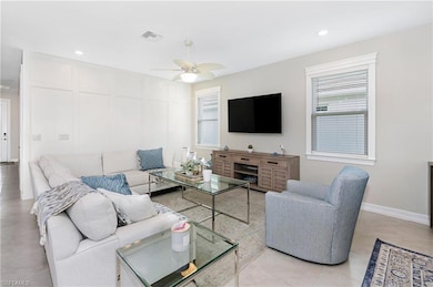 Tiled living room with ceiling fan and a wealth of