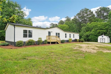 Back of property featuring a storage unit, an outb