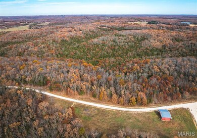 Aerial overview of property's location with a forest