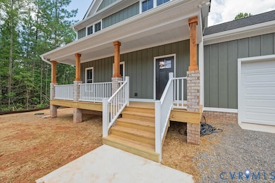 View of exterior entry with covered porch, board and batten siding, a garage, and roof with shingles