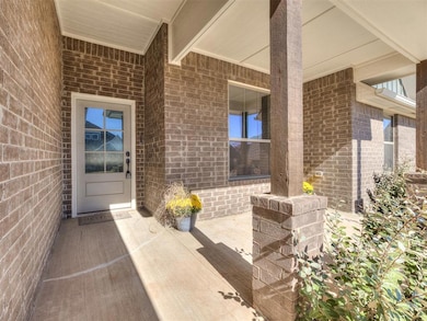 Doorway to property with brick siding and a patio area