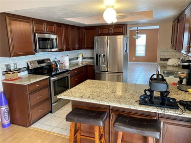 Granite counters, overhang for stools, wood cabine