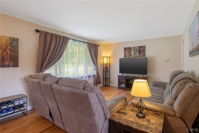 The living room is brightened by the newer large w