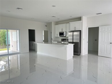 Kitchen featuring visible vents, white cabinets, m