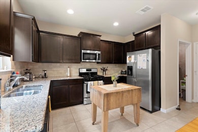 Kitchen featuring appliances with stainless steel