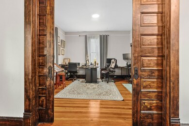 Pocket doors lead to the Living Room
