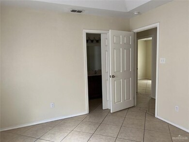 Unfurnished bedroom featuring light tile patterned flooring and baseboards