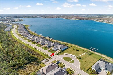 Birds eye view of property with a water view