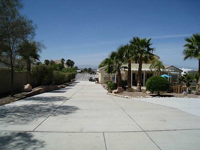 Parking Lot. South side RV parking (and more) looking towards the front gate from the detached 3 car garage/shop.