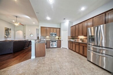 The homes kitchen is open to the living area. The