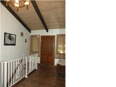 Tiled entry with vaulted ceiling.