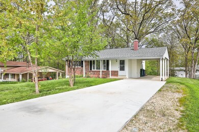 Extended concrete driveway leads to the 34x13 Carp