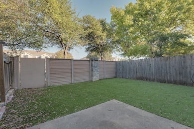 Fenced backyard with a patio area