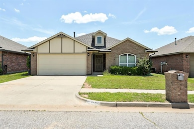 View of front of house featuring a 2 car garage, concrete driveway, and beautiful front yard.