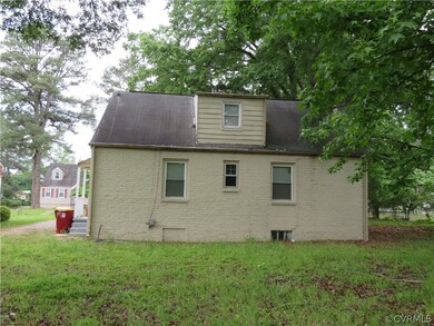 Back of house with a yard