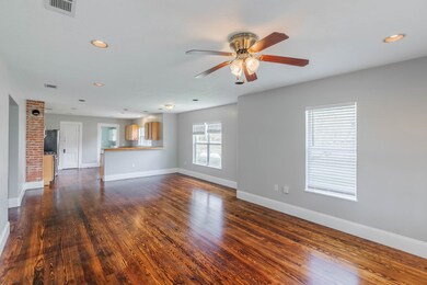 Completely remodeled family room with wood floors, tall base boards and fresh paint.
