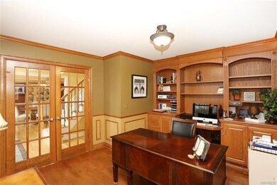 The office/den offers  hardwood flooring, custom w
