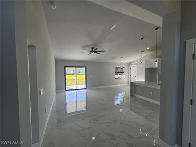 Unfurnished living room featuring ceiling fan