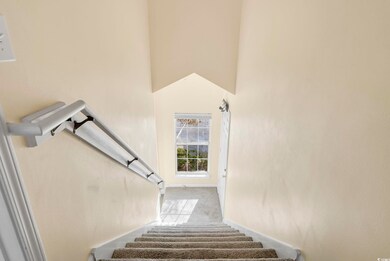 Stairs featuring a high ceiling and carpet floors
