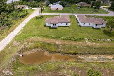 Aerial view of residential area featuring a nearby body of water