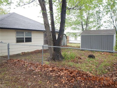 Back and side yard fencing and storage buildings.