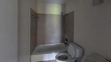 Full bath featuring toilet and shower / bathtub combination